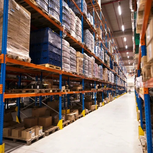 interior-large-distribution-warehouse-with-shelves-stacked-with-palettes-goods-ready-market